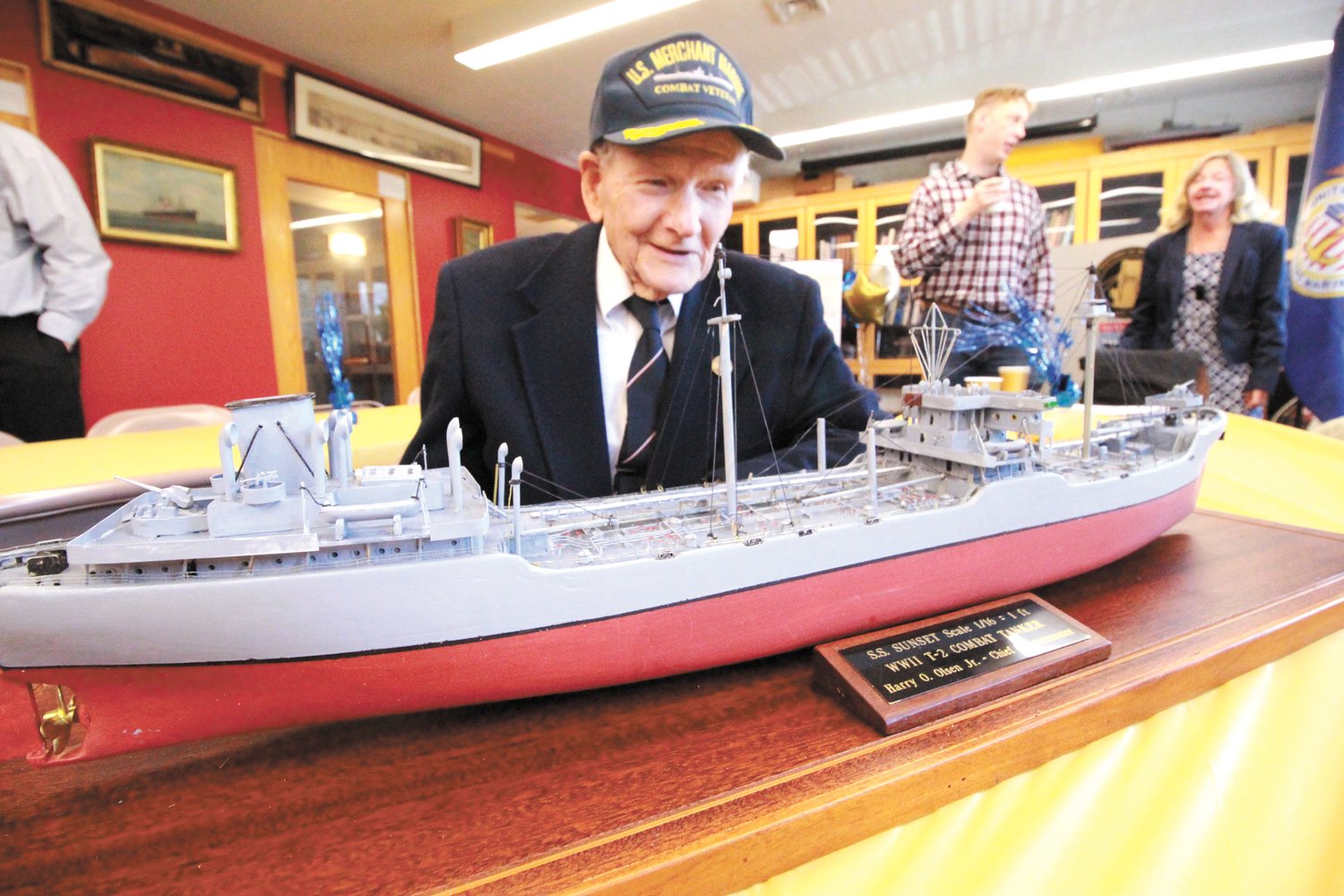 THE SHIP HE SAILED: Harry Olsen pictured with a model of the tanker he served on at the recent Steamship Historical Society of America reception held in recognition of him receiving a Congressional Gold Medal.